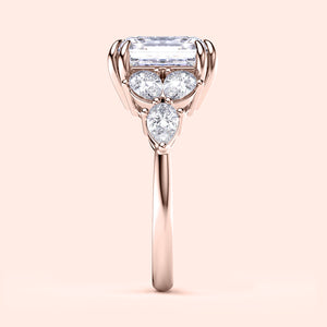 "Elegant 14K rose gold engagement ring with asscher and pear-cut diamonds, featuring exquisite side stones, perfect for timeless love."