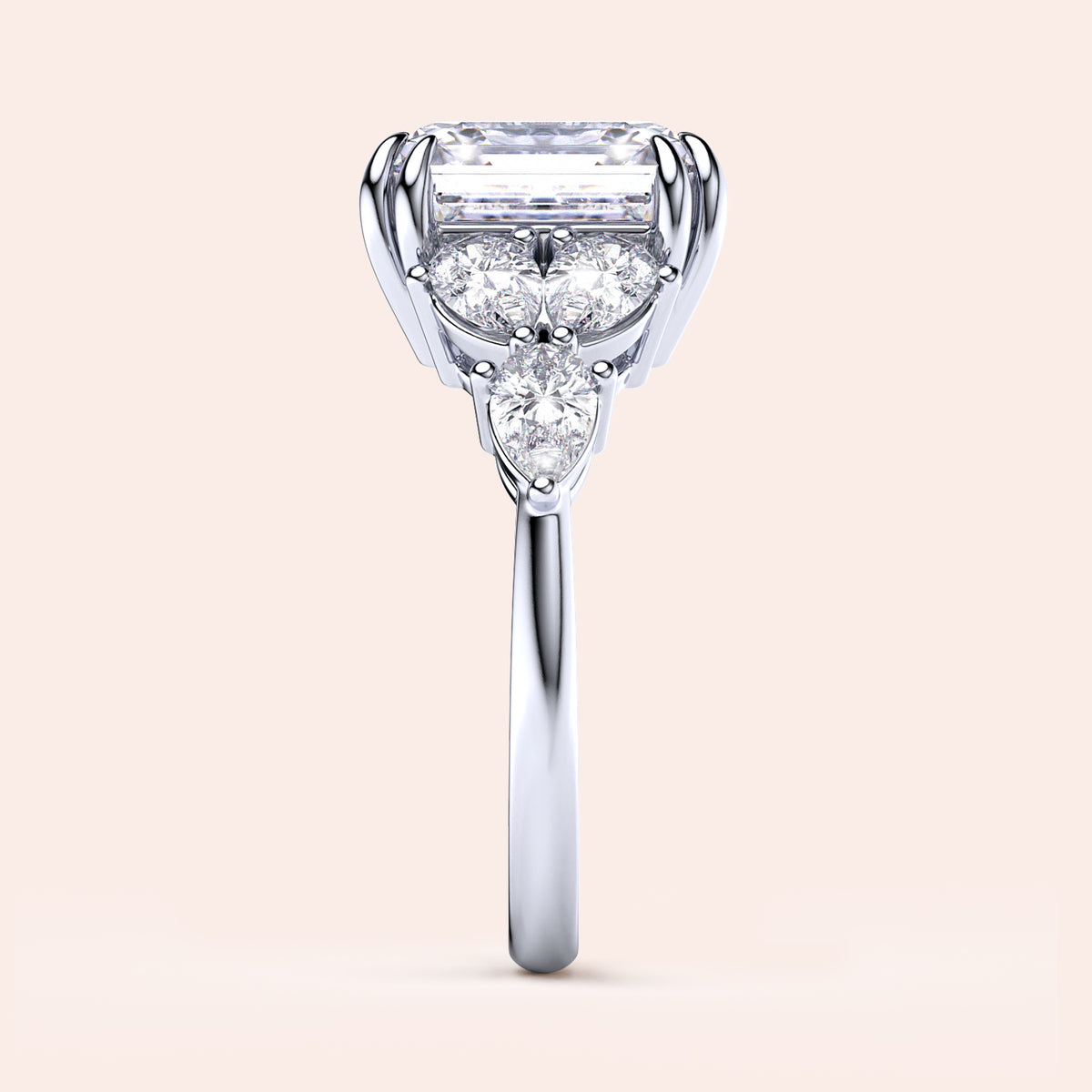 Elegant engagement ring in 14K/18K white gold featuring an elongated radiant-cut diamond, pear-shaped and round diamonds.