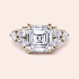 Asscher cut diamond engagement ring with side stones in a stunning 14K yellow gold setting. Perfect for timeless elegance.