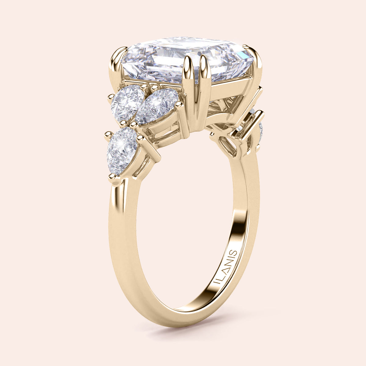 14K yellow gold engagement ring featuring an asscher and pear cut diamond centerpiece with accenting diamonds in a floral design.