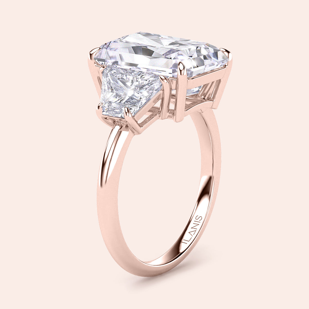 Elegant rose gold engagement ring featuring an emerald-cut diamond and trapezoid accents, available in 14K, 18K, or platinum.