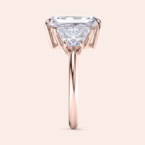 "Elegant 14K rose gold engagement ring with a stunning three-stone trapezoid design, showcasing radiant diamonds in exquisite prong settings."