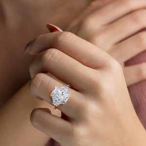 Stunning 14K rose gold radiant three-stone trapezoid diamond ring on a model's finger, showcasing exquisite craftsmanship and brilliance.