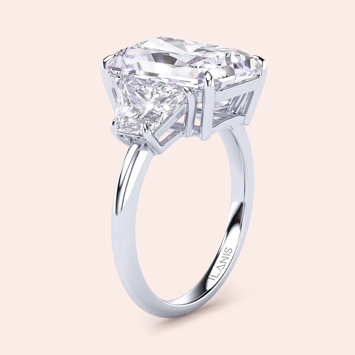 Elegant 14K/18K platinum engagement ring with a radiant three-stone design, featuring an emerald-cut diamond and trapezoid accents.