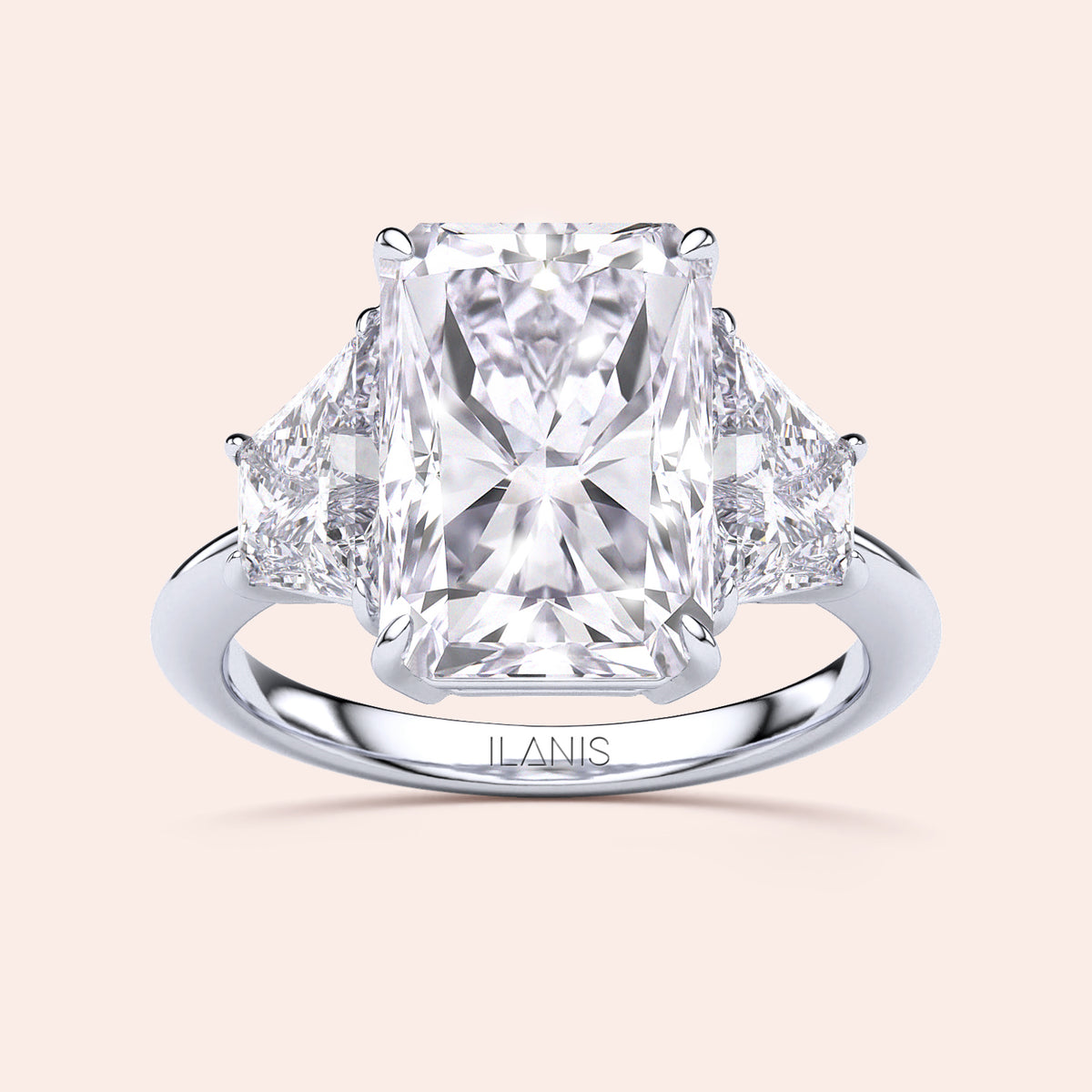 Radiant three-stone engagement ring in 14K white gold, featuring a radiant-cut diamond flanked by brilliant triangular diamonds.