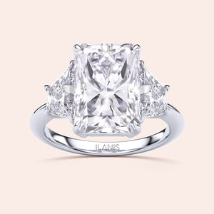 Radiant three-stone engagement ring in 14K white gold, featuring a radiant-cut diamond flanked by brilliant triangular diamonds.