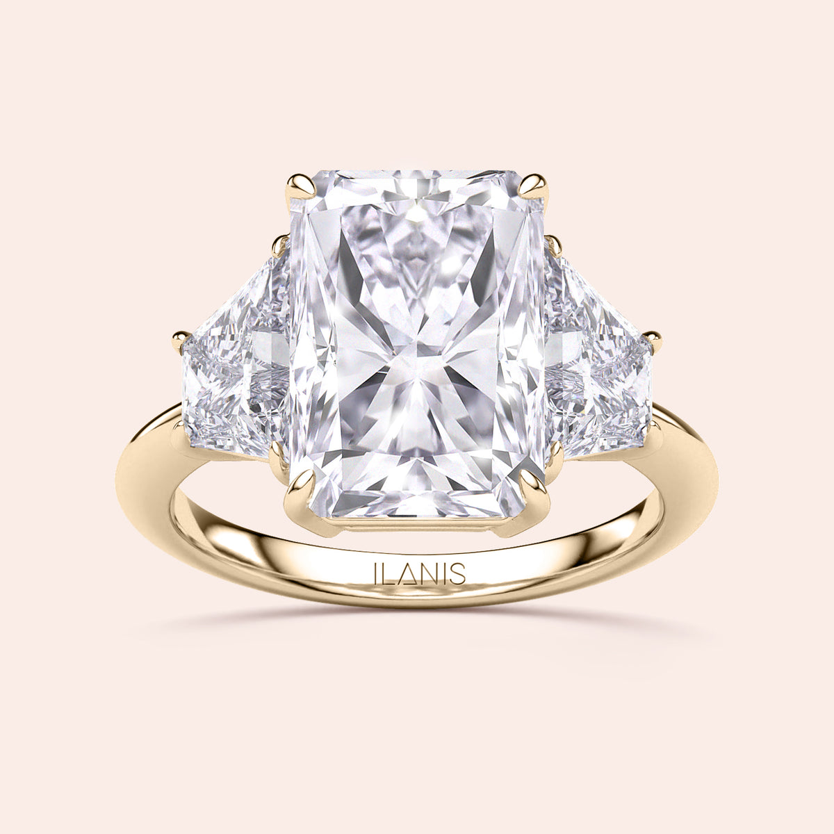 "Elegant 14K or 18K yellow gold engagement ring featuring a radiant-cut diamond and two trapezoid diamonds, handcrafted by ILANIS."
