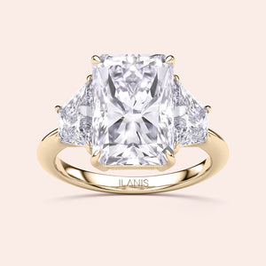 "Elegant 14K or 18K yellow gold engagement ring featuring a radiant-cut diamond and two trapezoid diamonds, handcrafted by ILANIS."