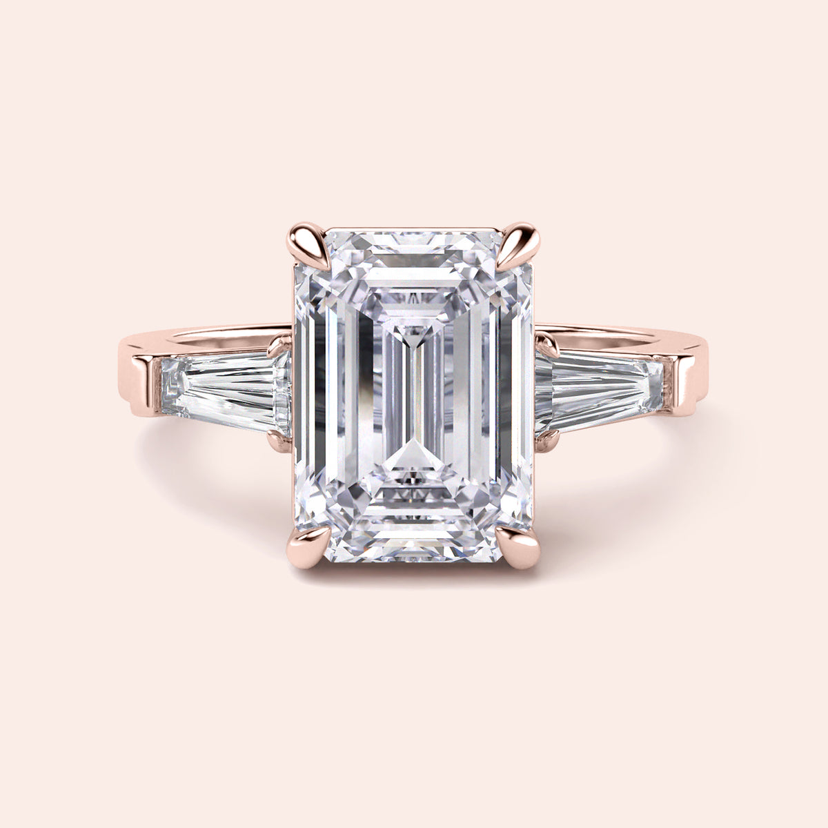 Elegant 14K Rose Gold engagement ring featuring emerald cut and tapered baguette diamonds, perfect for timeless beauty.