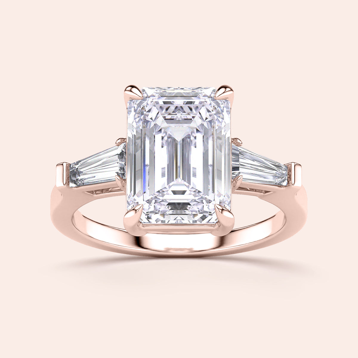 Emerald-cut diamond ring with tapered baguette side stones in 14K rose gold, perfect for elegant engagements.