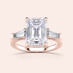 Emerald-cut diamond ring with tapered baguette side stones in 14K rose gold, perfect for elegant engagements.