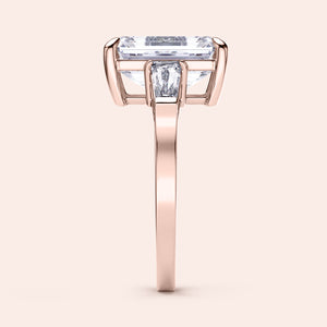 Elegant 14K rose gold engagement ring featuring emerald three stone tapered baguettes for a sophisticated design.