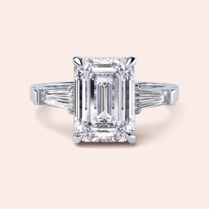 Emerald cut diamond ring in 14K or 18K white gold or platinum with tapered baguette side stones for a stunning engagement.