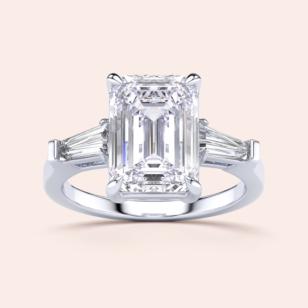 Elegant engagement ring with emerald-cut diamond and tapered baguette side stones, available in 14K or 18K gold, or platinum.