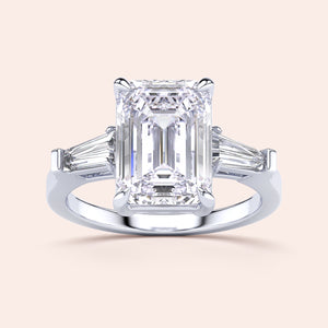 Elegant engagement ring with emerald-cut diamond and tapered baguette side stones, available in 14K or 18K gold, or platinum.