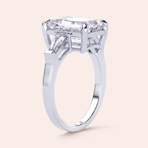 Elegant emerald-cut diamond ring featuring three tapered baguettes, crafted in 14K or 18K white gold or platinum.