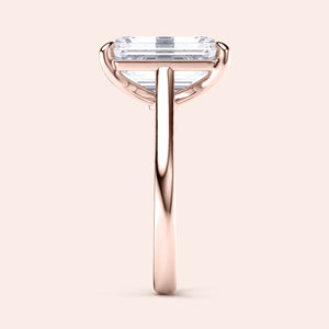 Elegant emerald solitaire cathedral engagement ring in 14K or 18K rose gold, showcasing a minimalist design and timeless beauty.