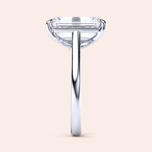 Emerald-cut diamond engagement ring in 14K/18K white gold, showcasing an elegant solitaire setting from the side view. Not worn on model.