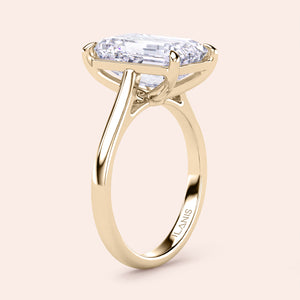 Elegant 14K yellow gold engagement ring featuring a stunning emerald-cut diamond in a sophisticated claw setting.