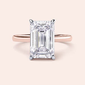 Elegant two-tone 14K/18K white and rose gold emerald-cut diamond engagement ring in a cathedral setting. 