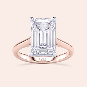 Two-tone emerald-cut diamond ring in 14K/18K white and rose gold, featuring a stunning cathedral design. 