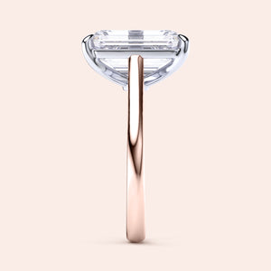 Two-tone 14K/18K white and rose gold engagement ring with an emerald-cut diamond in a cathedral setting. 