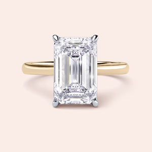 Two-tone 14K/18K gold emerald-cut diamond engagement ring in white and yellow gold, featuring a striking cathedral design. 