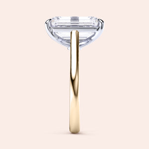 Two-tone 14K/18K gold engagement ring featuring an emerald-cut diamond in white and yellow gold. 