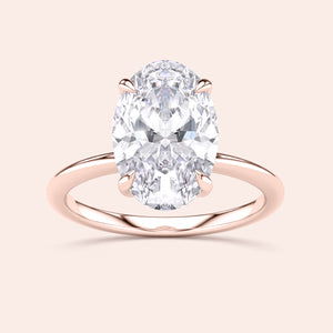 Elegant oval-shaped diamond engagement ring in a 14K rose gold band with hidden halo, perfect for a timeless love.