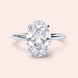 "Elegant 14K/18K/Platinum oval-cut diamond engagement ring with a sleek band and hidden halo, ideal for lasting love."