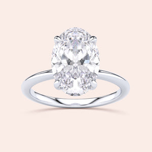 Elegant oval diamond engagement ring with a simple band, available in 14K, 18K gold, or platinum.