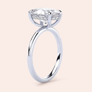 Elegant 14K white gold oval solitaire engagement ring with hidden halo, featuring intricate detailing and a stunning diamond.