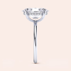 Elegant 14K/18K White Gold Oval Solitaire Engagement Ring with Hidden Halo and Diamonds, featured in a minimalist studio setting.