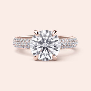 Round brilliant cut diamond engagement ring in rose gold, featuring a delicatePave band; available in 14K or 18K gold or platinum.