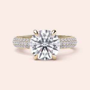 Elegant 14K yellow gold engagement ring featuring a round-cut diamond centerpiece andPave diamond band, close-up view.