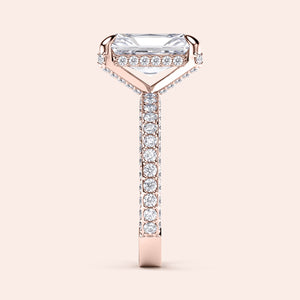Elegant 14K rose gold engagement ring featuring a radiant cut diamond on a pave band, beautifully worn on a model.