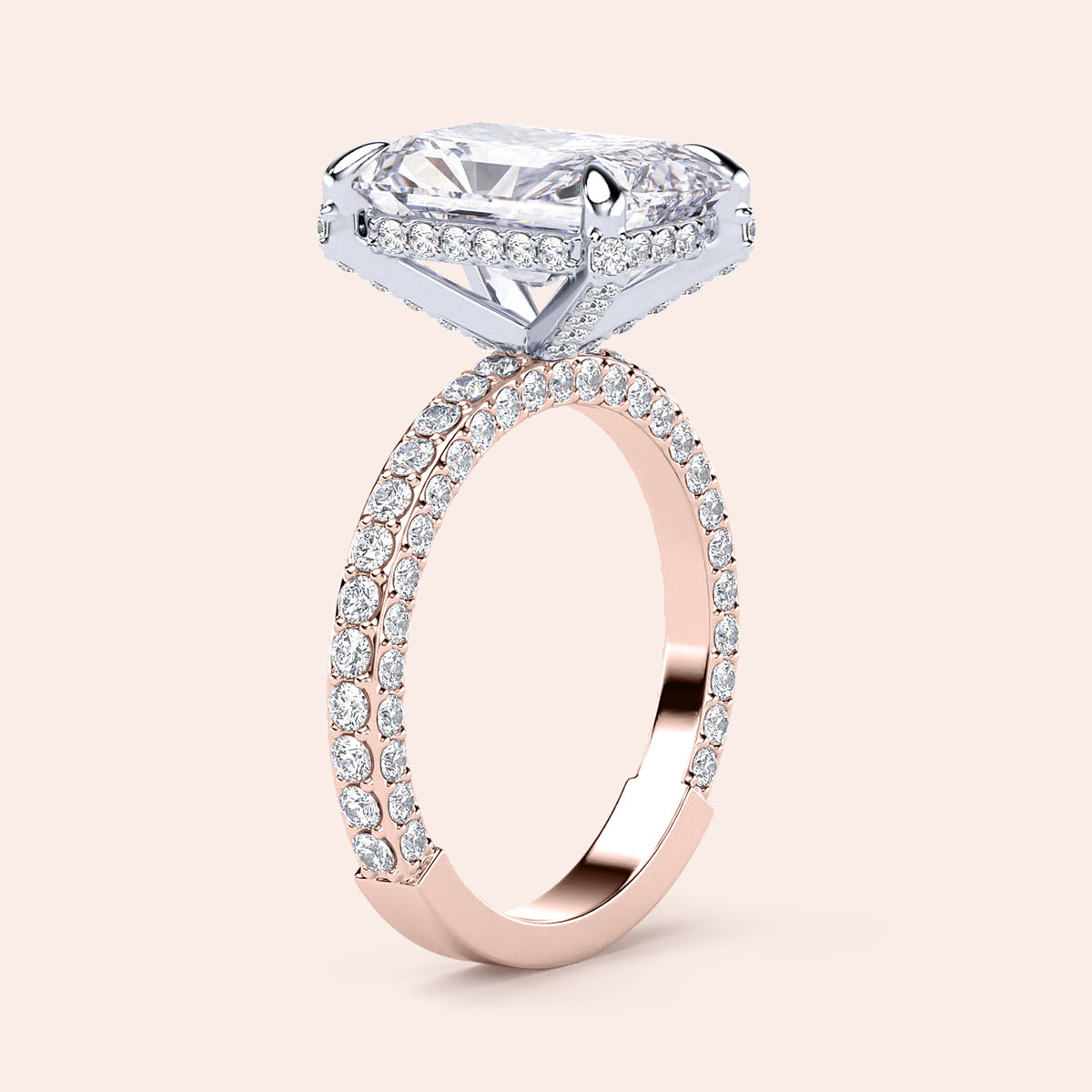 Two-tone 14K white and rose gold diamond ring featuring an emerald-cut stone, perfect for stylish weddings or engagements. 