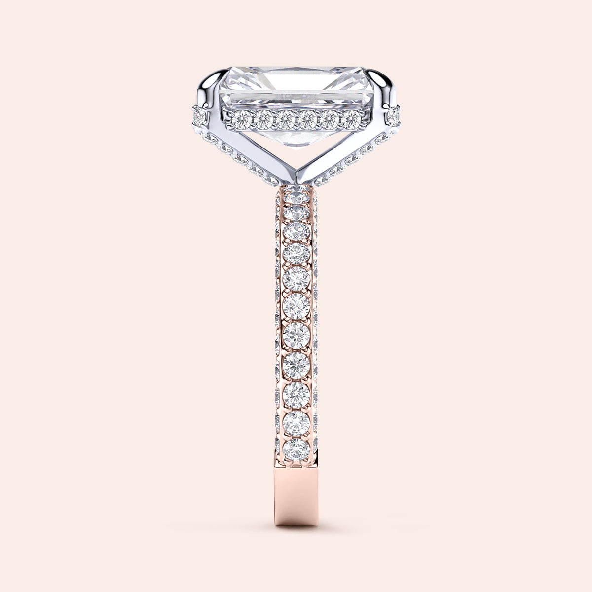 Two-tone 14K/18K white and rose gold diamond ring featuring an emerald-cut stone, showcased on a model's hand. 