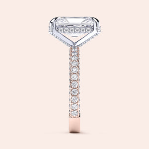 Two-tone 14K/18K white and rose gold diamond ring featuring an emerald-cut stone, showcased on a model's hand. 