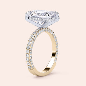 Two-tone 14K gold emerald-cut diamond ring with pav‚ setting, featuring a radiant hidden halo in white and yellow gold. 