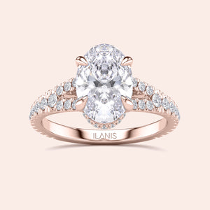 Elegant oval-cut diamond engagement ring in 14K rose gold, featuring a stunning round diamond-studded band for timeless beauty.