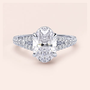 Elegant oval-shaped diamond engagement ring in 14K/18K gold or platinum with a dazzling diamond-encrusted band.