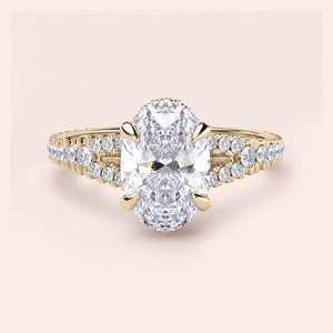 Elegant 14K gold solo engagement ring featuring an oval-cut diamond with a split shank and round diamonds.