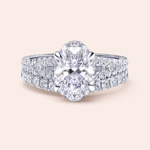 Elegant 14K white gold oval diamond engagement ring with split shank and pave-set diamonds, perfect for timeless romance.