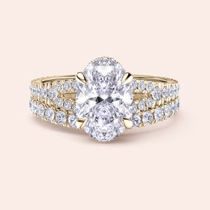 Stunning yellow gold oval diamond engagement ring with doublePave band, featuring brilliant diamond and four-prong setting.