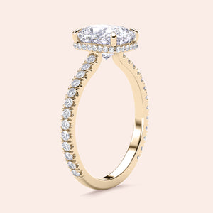 Elegant oval diamond engagement ring withPave-set band in yellow gold, available in 14K or 18K options.