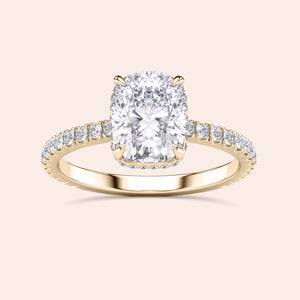 Elegant 14K or 18K gold engagement ring with a cushion-cut diamond center and side stones, showcasing timeless sophistication.