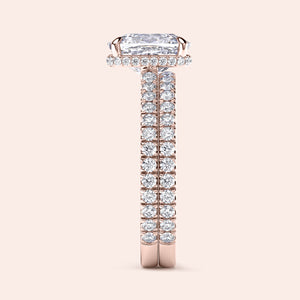 Elegant 14K rose gold engagement ring with elongated cushion-cut diamond and halo, featuring a diamond-studded band.