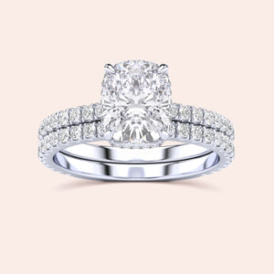 Elegant 14K white gold cushion-cut diamond engagement ring and wedding band set with halo, showcasing exquisite craftsmanship.