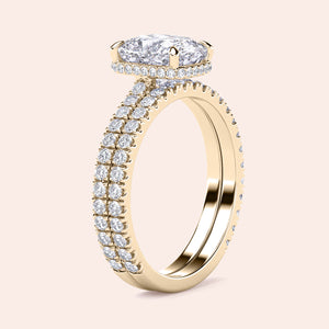 Elegant 14K yellow gold engagement ring set with oval diamond andPave detailing, showcased on model's finger.